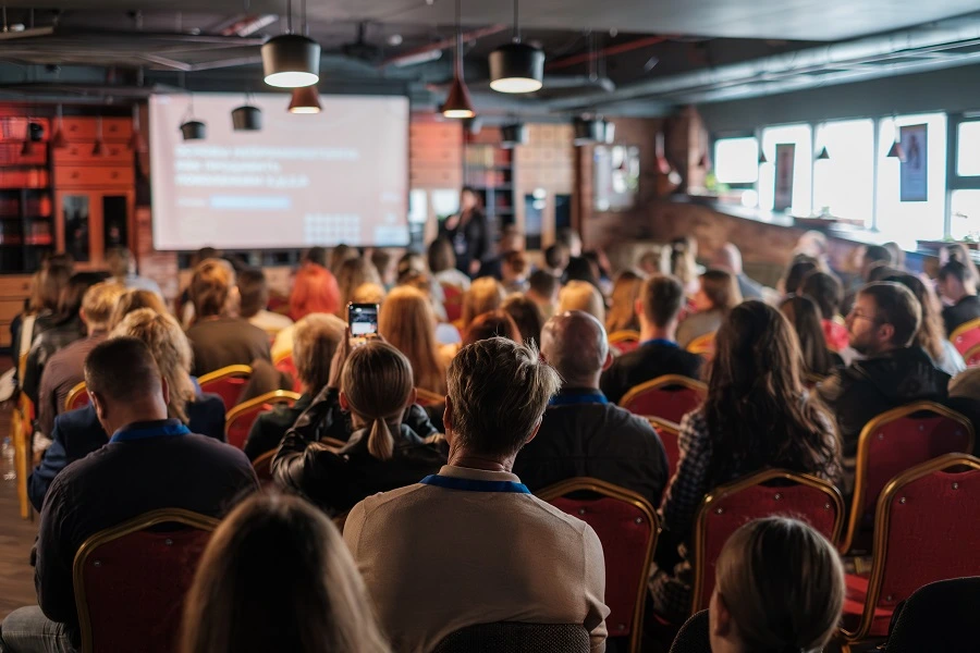 group of people listening to a seminar at an event